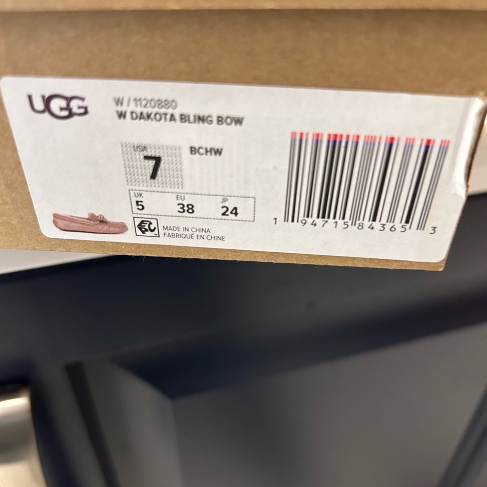 New, in box, never worn Ugg size 7 Dakota Bling Bow